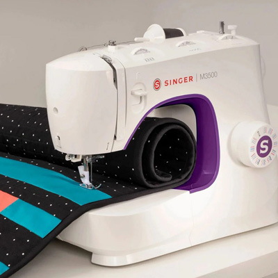 SINGER<sup>&reg;</sup> M3500 Sewing Machine - Perfect for any type of sewing. 110 Stitch applications support a wide variety of sewing techniques with 32 Built-in stitches for basic sewing. One-Step Buttonhole - place button in buttonhole foot and machine sews perfectly. Built-in needle threader eliminates eye strain. Front loading bobbin, easy stitch selection dial,  and adjustable stitch length. Reverse lever assists with beginning and end seams. Features LED lighting that illuminates work.